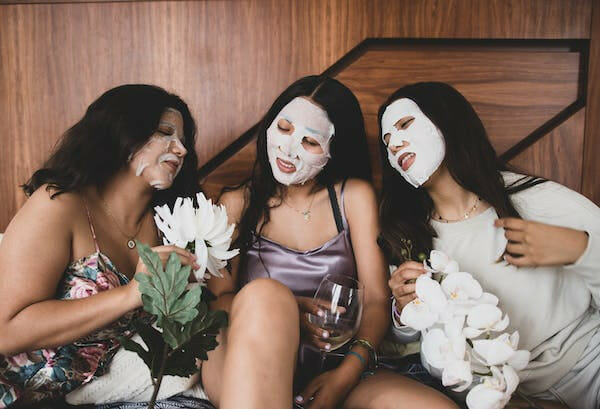 3 women friends bonding with their beauty face mask session