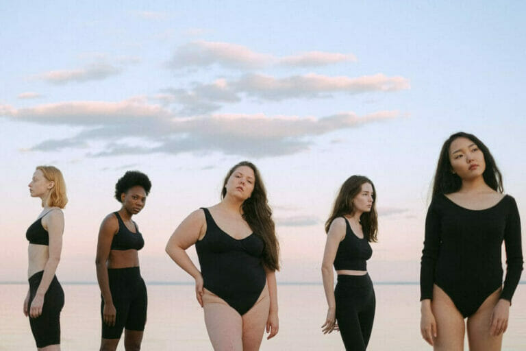 5 women of different sizes and shapes wearing black shaper wears