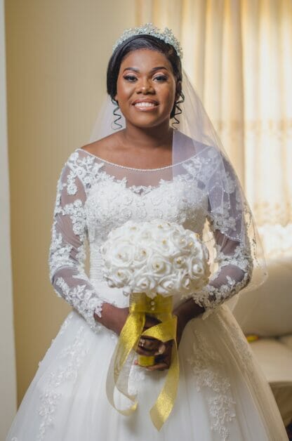 a bride smiling holding her bouquet