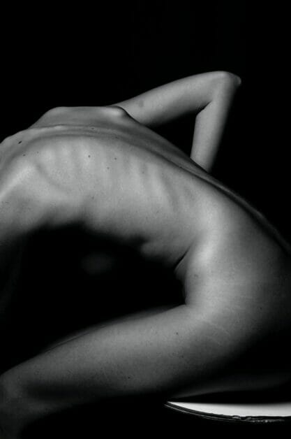 a photograph of the side of a naked woman