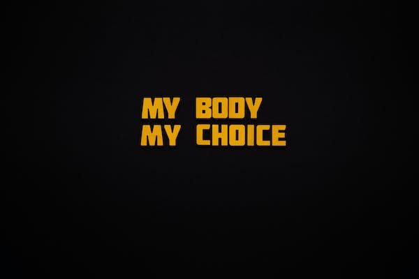 a yellow letter quote in a black backdrop that says: MY BODY MY CHOICE