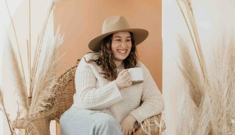 gorgeous plus size woman all smiles holding a cup of coffee
