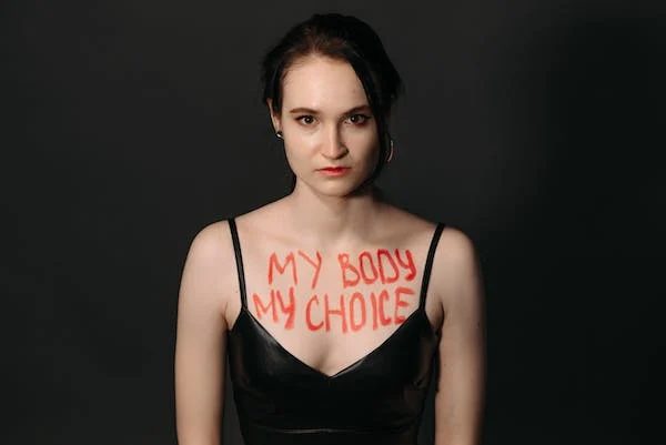 "my body my choice" paint written on the chest part of the woman's body