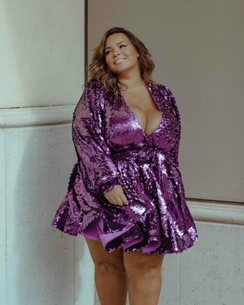plus-size waman in a glittery halted violet dress
