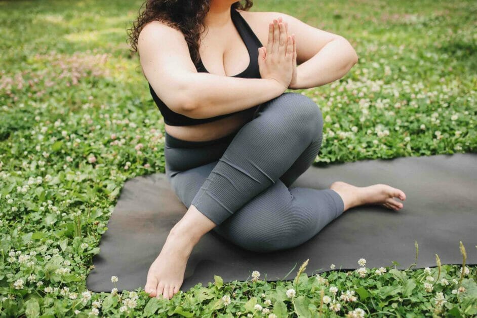 plus size woman doing an outdoor yoga