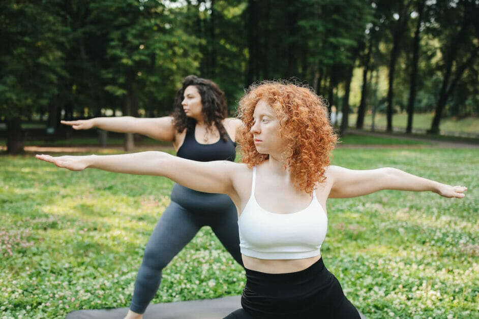 two woman doing yoga outdoor