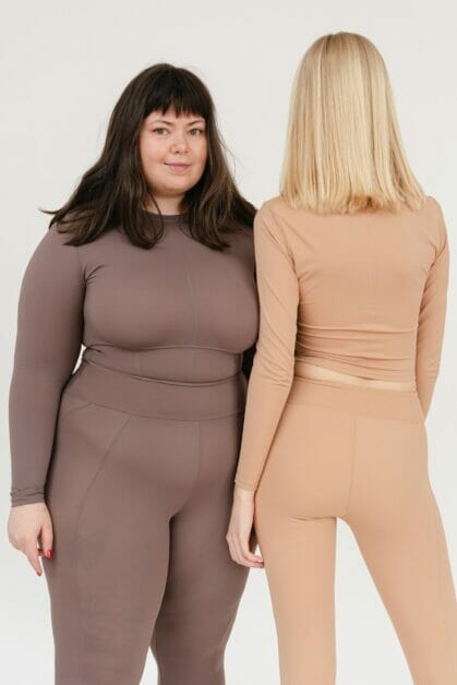 two woman of different body type, one facing the camera, one its back on the camera