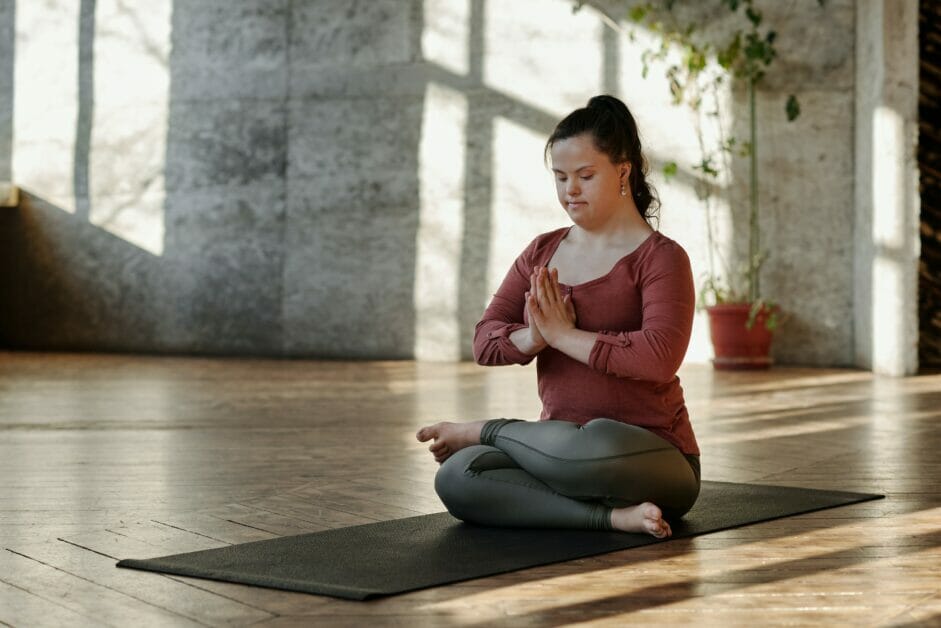 woman doing yoga's seated namaste position