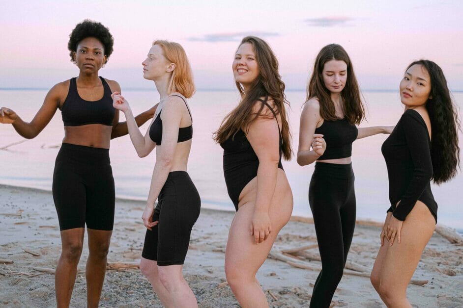 women of different shapes and sizes posing at the beach