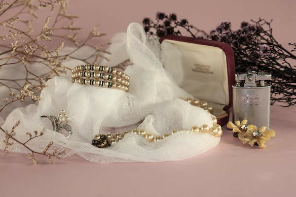 a zoom shot of accessories; bracelet, necklace, ring, brooch