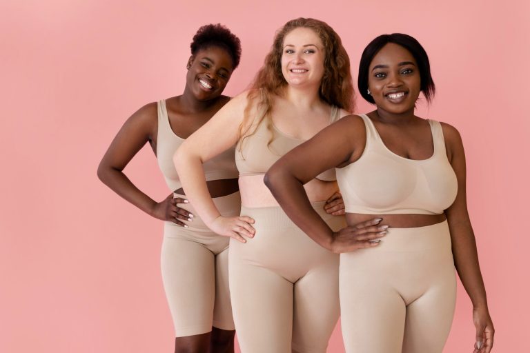 three happy women posing while wearing body shaper